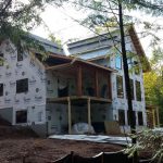 custom timber frame home exterior being built