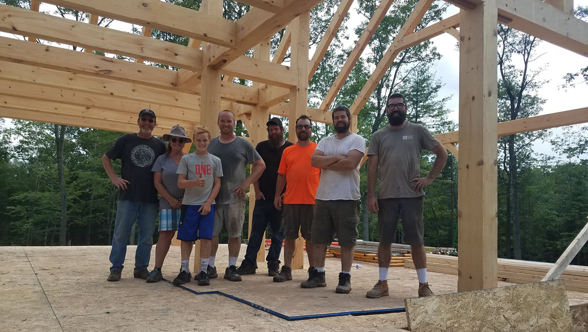 group of people under custom timber frame