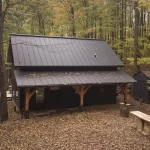 black timber cabin exterior with metal roof